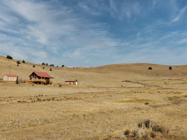 view of yard with a rural view and an outdoor structure