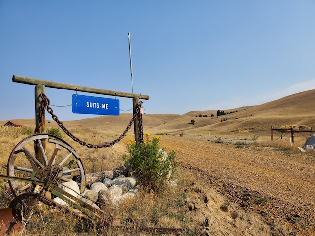 community sign with a rural view