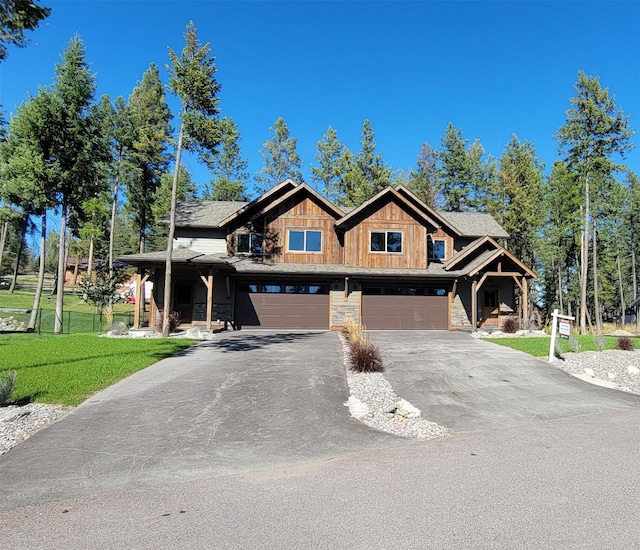 view of front of home featuring a garage and a front yard