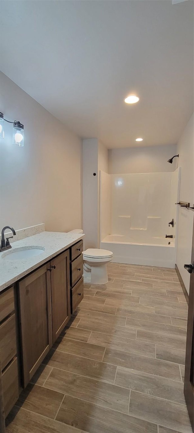 full bathroom featuring vanity, bathtub / shower combination, and toilet