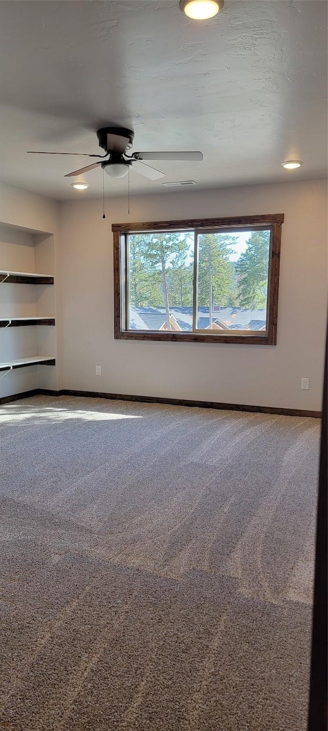 spare room with carpet flooring and ceiling fan