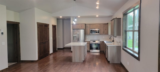 kitchen featuring sink, hanging light fixtures, dark wood-type flooring, a kitchen island, and appliances with stainless steel finishes