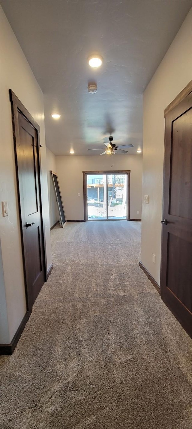 unfurnished room featuring ceiling fan and light colored carpet