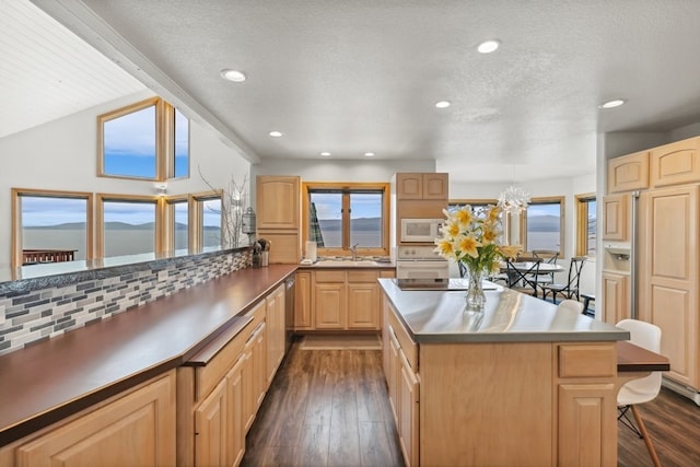 kitchen featuring lofted ceiling with beams, white appliances, light brown cabinets, and dark wood-style flooring