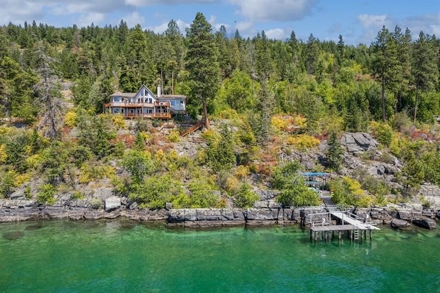 aerial view featuring a water view and a view of trees