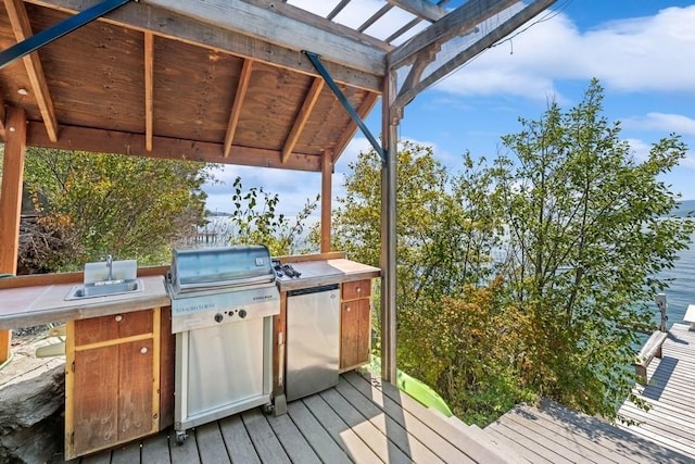 17431 Fishing Rock Ln, Bigfork, MT 59911 - wooden terrace with a sink and an outdoor kitchen
