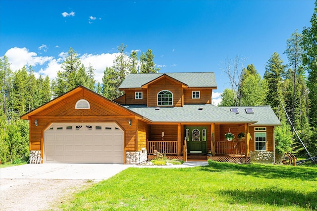 view of front of property featuring covered porch, a garage, and a front lawn