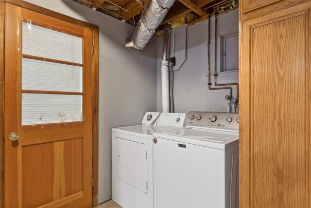 basement with washer and clothes dryer and white refrigerator