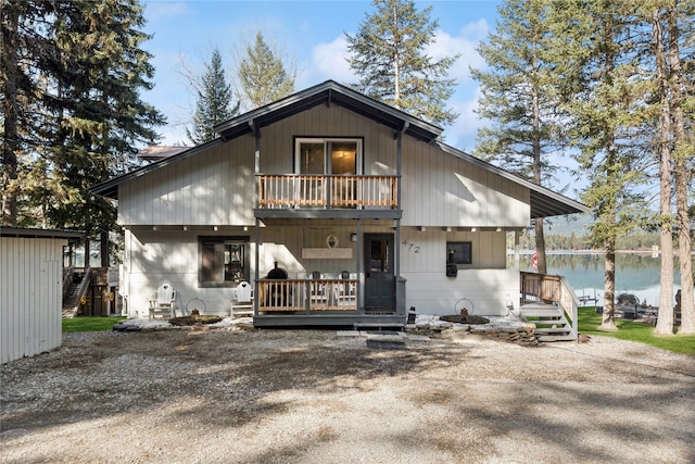 back of house with a storage unit