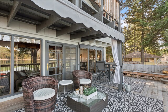 dining space with wooden walls, beam ceiling, dark hardwood / wood-style flooring, and a wealth of natural light