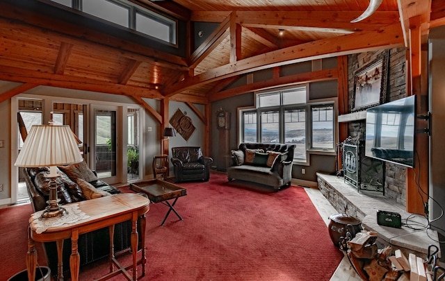 carpeted living room with beam ceiling, a stone fireplace, and wooden ceiling