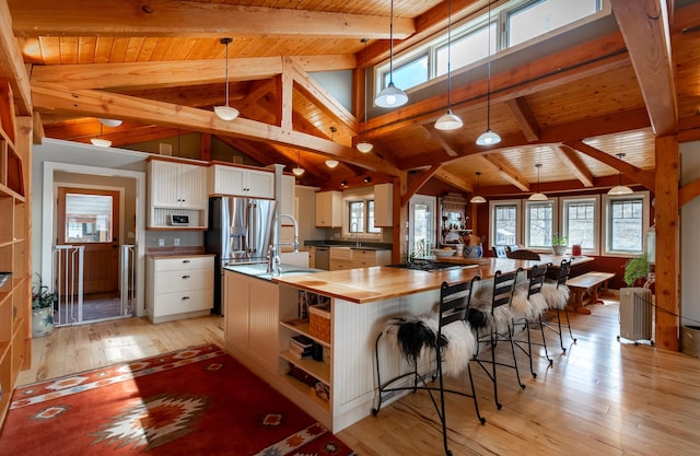 kitchen featuring pendant lighting, a spacious island, and white cabinets