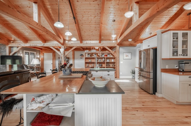 kitchen with white cabinets, high end refrigerator, pendant lighting, and wood ceiling