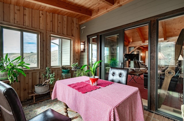 sunroom featuring beamed ceiling and wooden ceiling