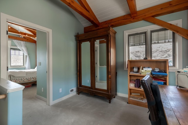 carpeted office featuring vaulted ceiling with beams