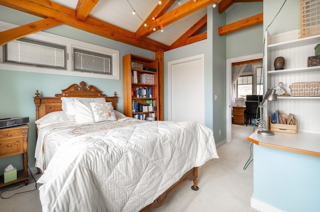 carpeted bedroom featuring vaulted ceiling with beams