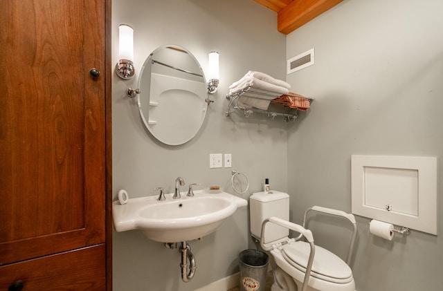 bathroom featuring toilet and sink