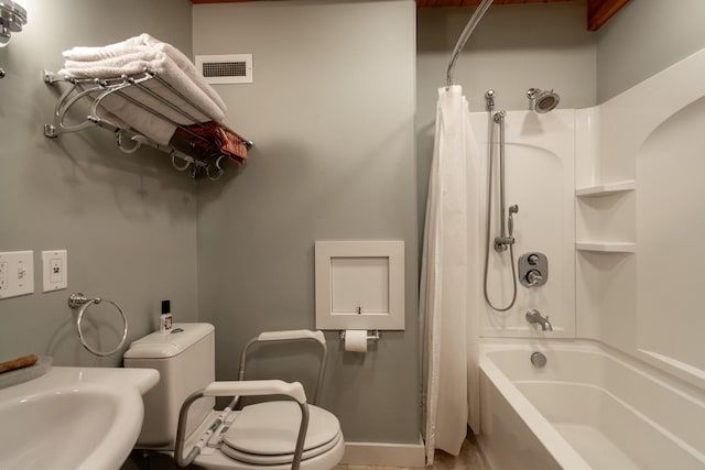 full bathroom with sink, shower / bath combo with shower curtain, and toilet