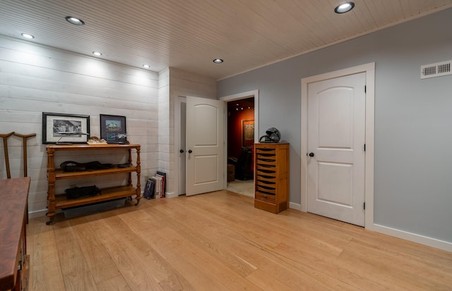 interior space featuring wooden ceiling, crown molding, and light hardwood / wood-style flooring