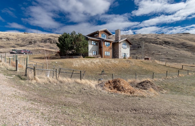 view of home's exterior with a rural view