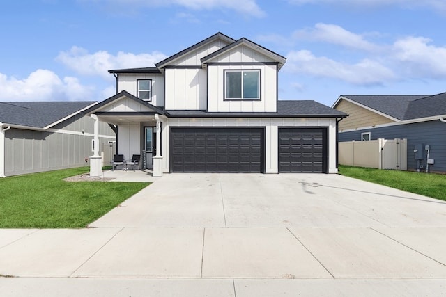 modern inspired farmhouse with a garage and a front lawn