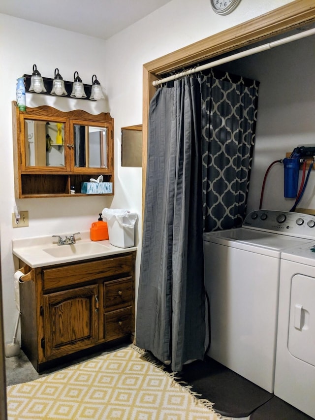 laundry area featuring light carpet, separate washer and dryer, and sink