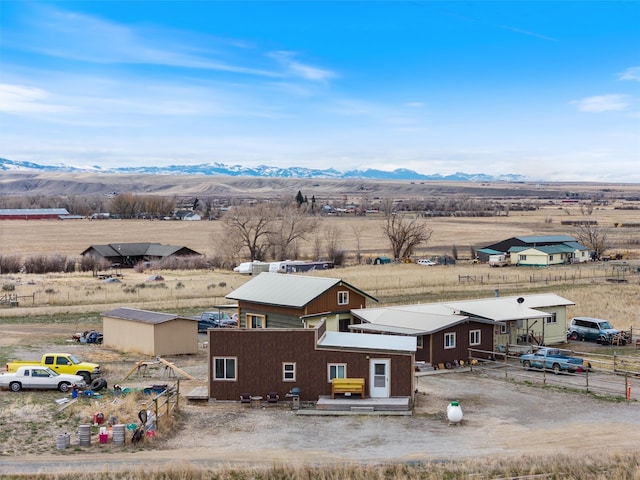 birds eye view of property featuring a mountain view and a rural view