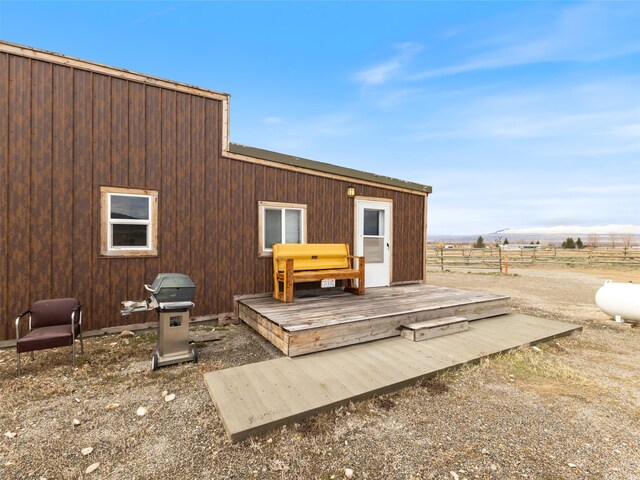 rear view of property featuring a wooden deck