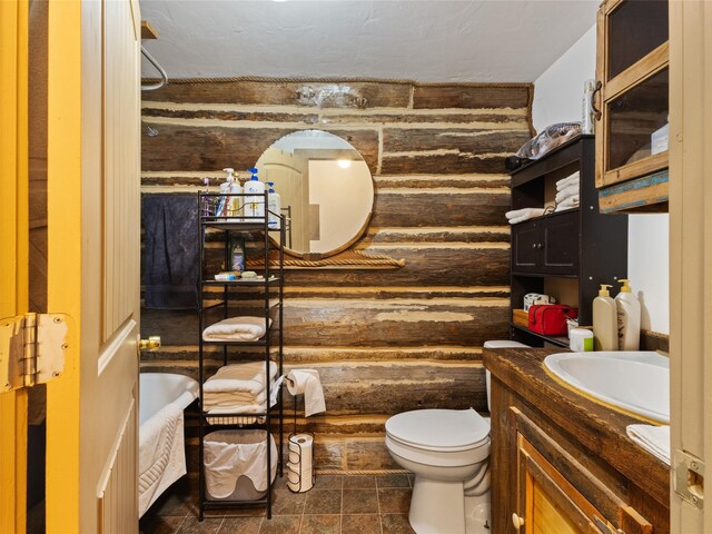 bathroom with a bathtub, tile floors, toilet, and vanity