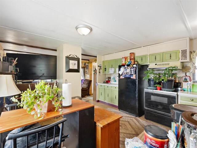 kitchen featuring green cabinetry, ventilation hood, and black appliances