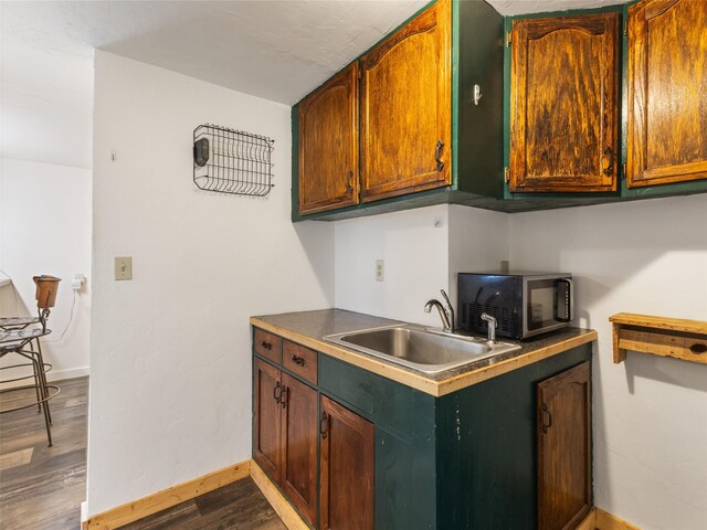 kitchen with dark hardwood / wood-style flooring and sink