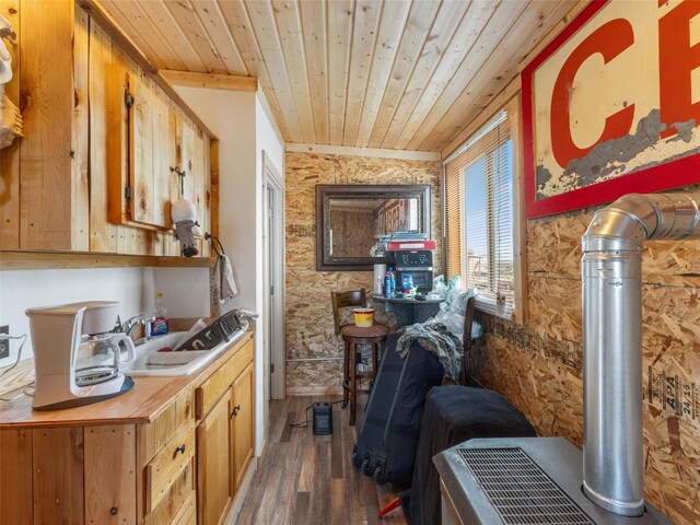 interior space with dark hardwood / wood-style floors, wood walls, and wood ceiling