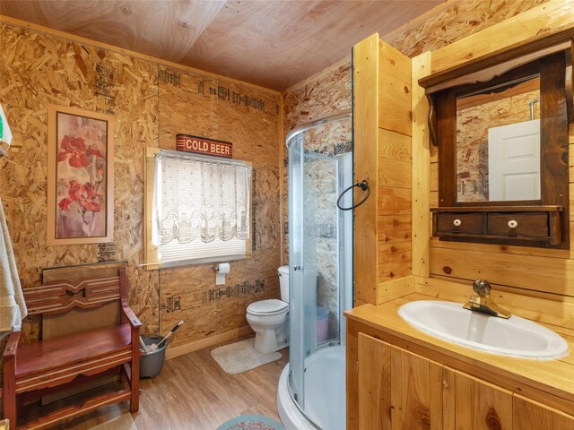 bathroom with wooden walls, toilet, wood ceiling, hardwood / wood-style flooring, and vanity