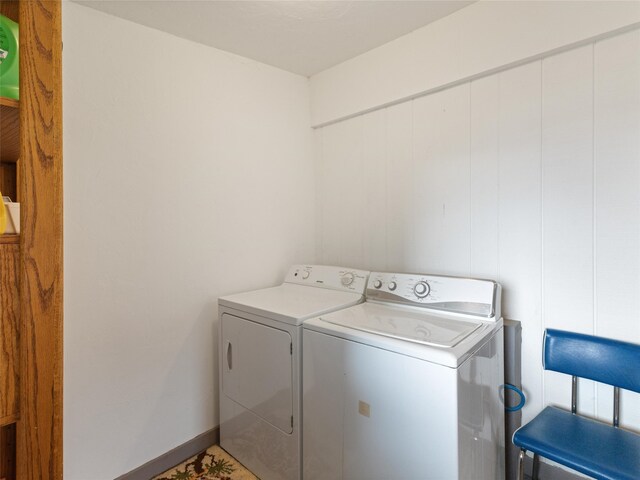 washroom featuring tile floors and washer and dryer