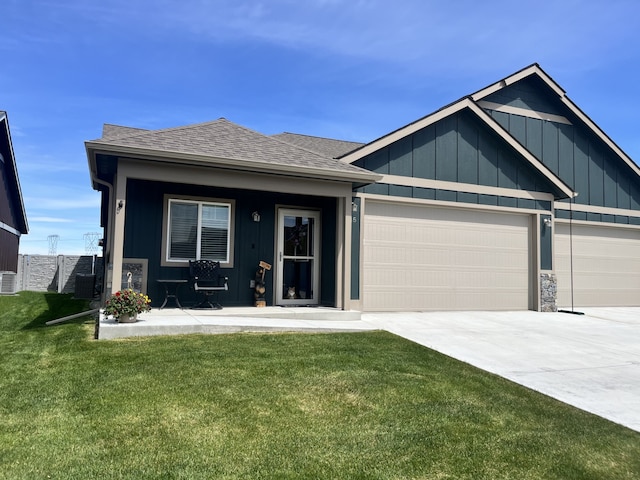 view of front of property featuring a garage and a front lawn