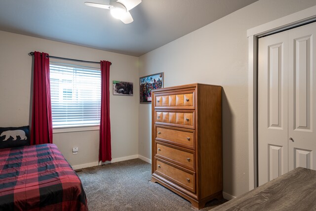 carpeted bedroom featuring a closet and ceiling fan