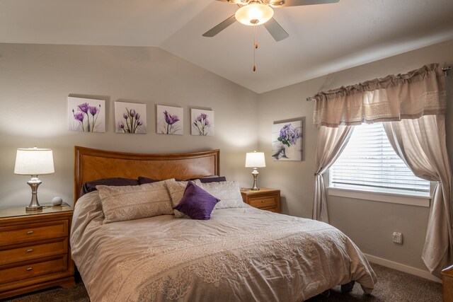 carpeted bedroom featuring ceiling fan and vaulted ceiling