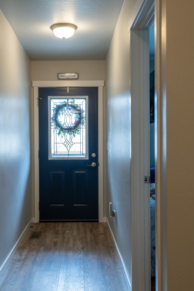 doorway to outside with hardwood / wood-style flooring