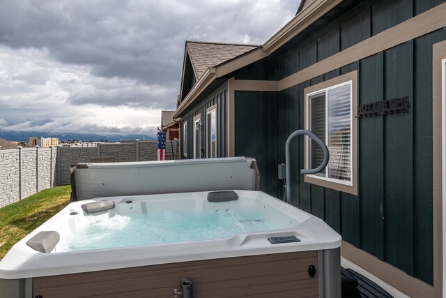 wooden terrace with a hot tub