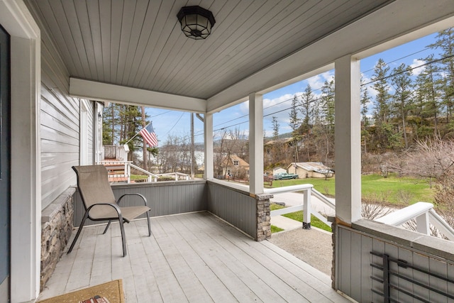 sunroom with a healthy amount of sunlight and wooden ceiling