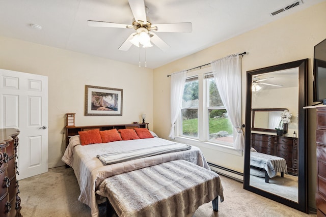 carpeted bedroom featuring ceiling fan and a baseboard radiator