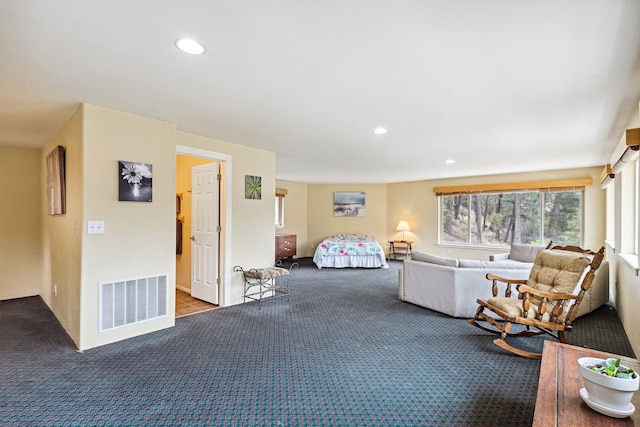 living room with carpet floors, visible vents, and recessed lighting