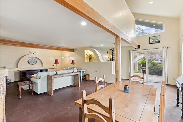 dining area featuring a glass covered fireplace, beam ceiling, recessed lighting, and concrete floors