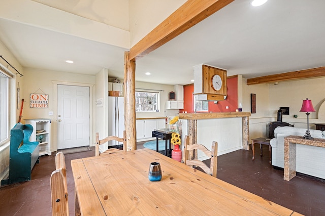 dining space featuring concrete flooring, a wood stove, and recessed lighting