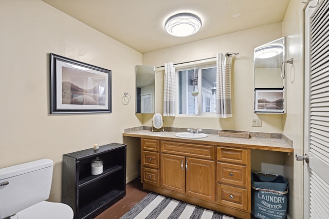 bathroom featuring vanity and toilet