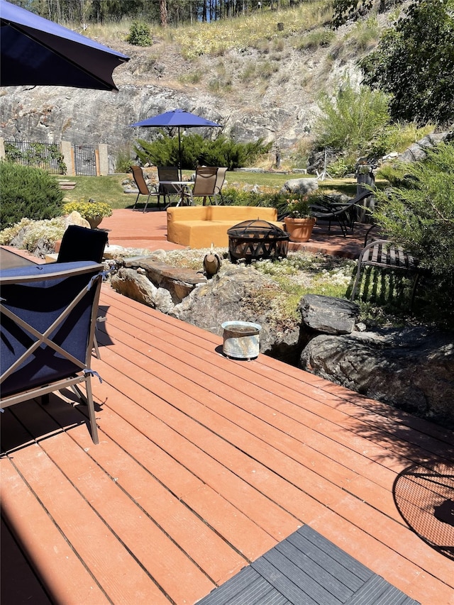wooden deck with fence and an outdoor fire pit