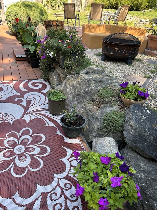 view of yard with a wooden deck and an outdoor fire pit