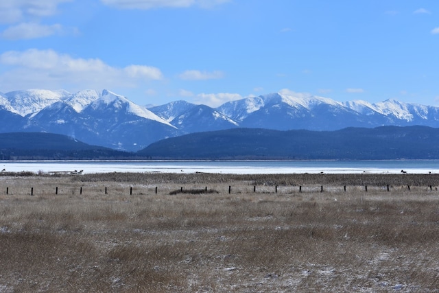 view of mountain feature with a rural view and a water view