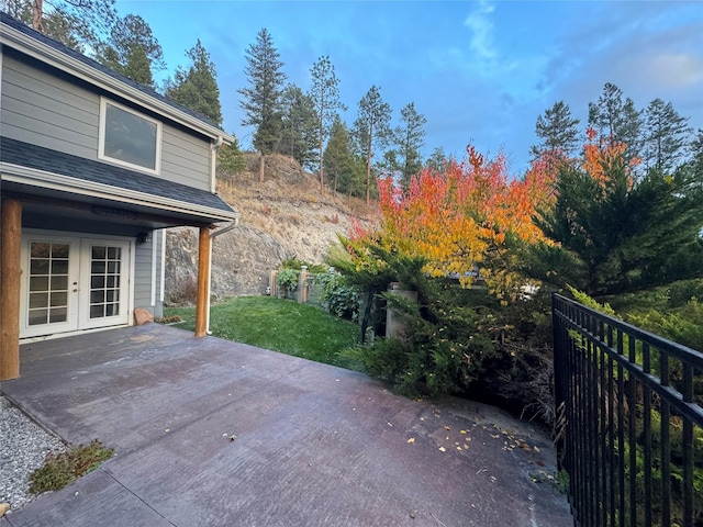 view of patio / terrace featuring french doors and fence