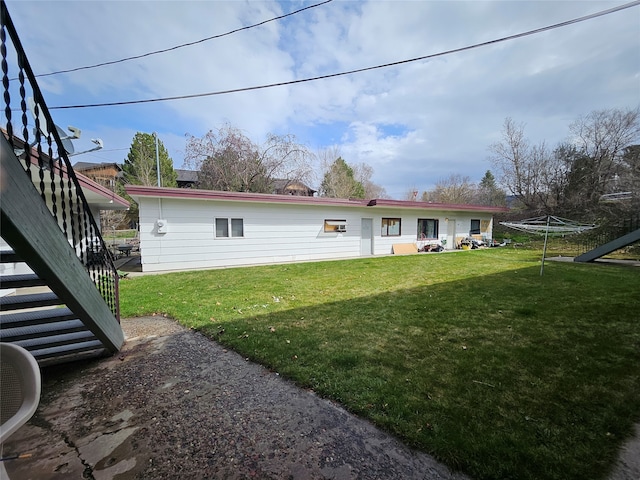 rear view of house with a lawn